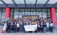 Over 120 cross-disciplined alumni and faculty members gather and pose for a group photo at the entrance of HKUST Shenzhen Research Institute