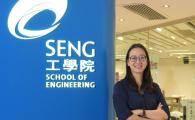 Prof. Liem standing besides the School of Engine logo