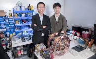 Prof. Shen Yajing (left) and co-first author Dr. Yang Xiong (right) with the magnetic actuation platform for microswimmer control in front. 