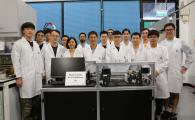 Prof. Sun Qingping (front row, fourth left), Prof. Yao Shuhuai (front row, third left), both Professors of Department of Mechanical and Aerospace Engineering (MAE), MAE Postdoctoral Research Associate Dr. Zhou Guoan (front row, second left), MAE PhD student Li Zexi (front row, first left), and other members of the research team with their elastocaloric air conditioner. 