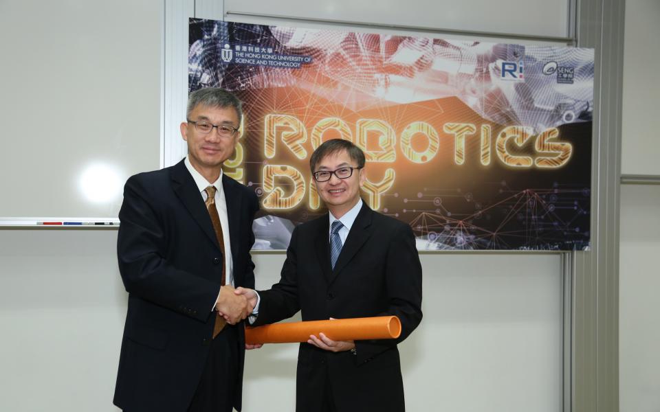 Prof Michael Wang (left) presenting a souvenir to Dr David Chung.