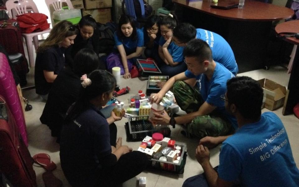 Put medicines in the trays of portable drug dispensary box