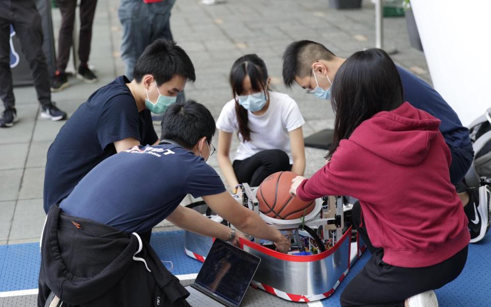 Team members worked hard to fine-tune the robot.