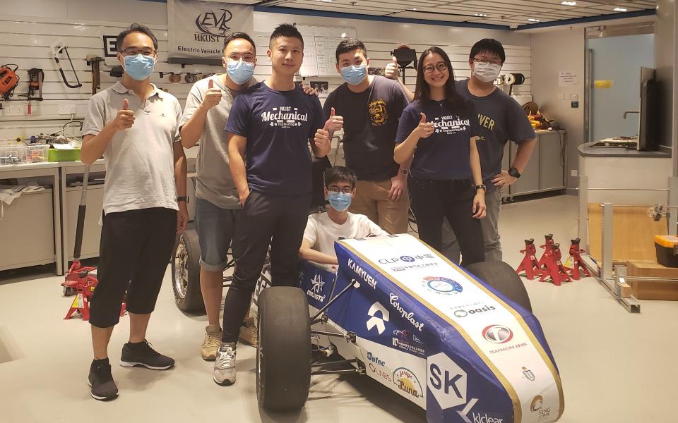 Prof. Liem and students with an Electronic Vehicle