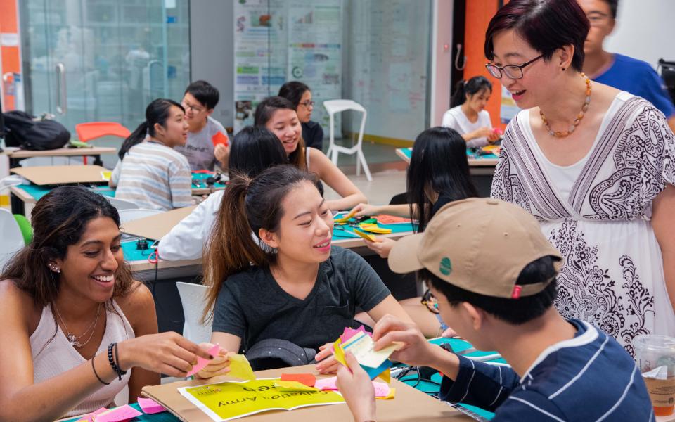 Students go through their post-it ideas with Prof. Chau before a prototyping session at the SIGHT camp.