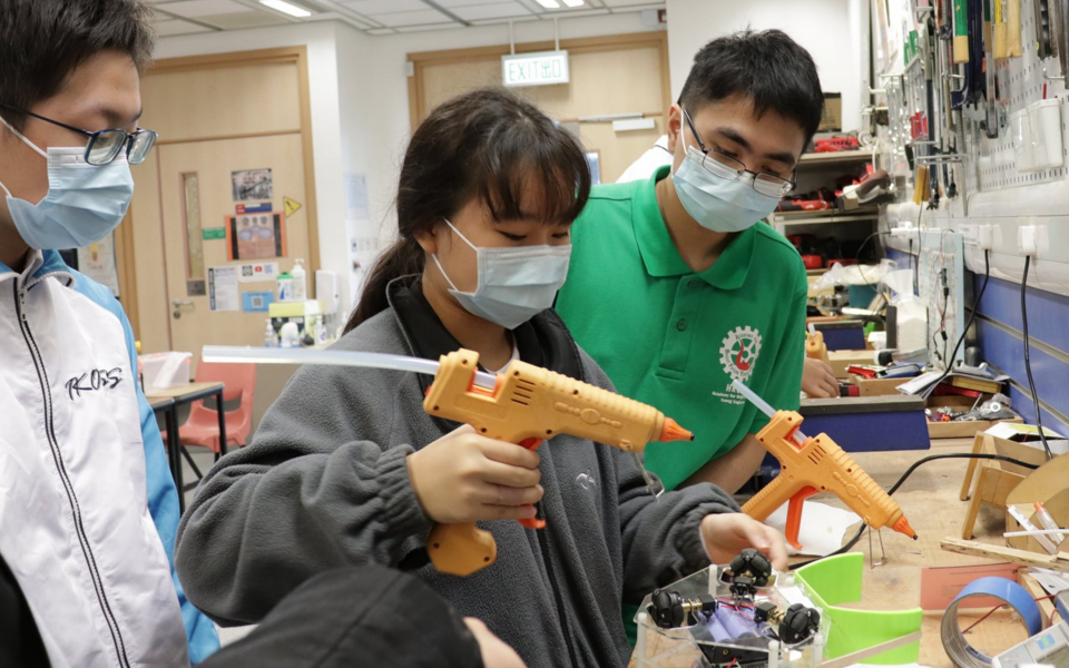 Students construct a soccer robot.