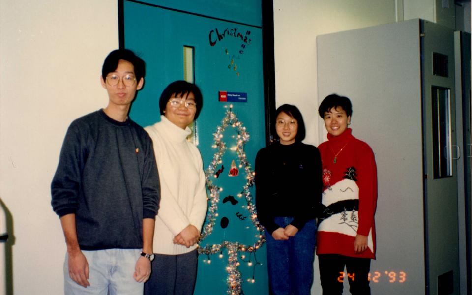 Prof. Ip (First right) celebrates first Christmas at HKUST in 1993 in front of her laboratory with her research team members, some of whom are still her aide to date.