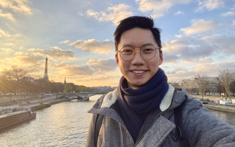 A photo of Roy by the Paris Seine River with Eiffel Tower at sight during sunset.  