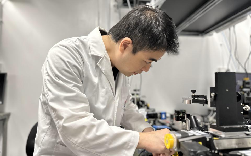 Prof. Terence Wong, pictured here working with the CHAMP microscope, aims to alleviate the suffering of cancer patients with his breakthrough in medical imaging technology.