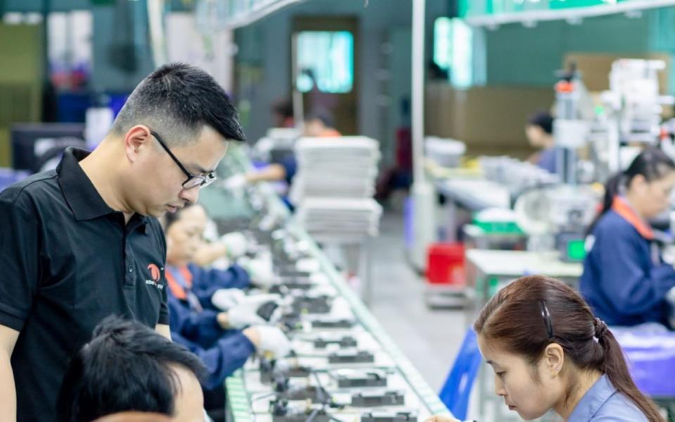 Dr. Louis Lam inspects the progress of a production line in Active Tools’ Dongguan plant.