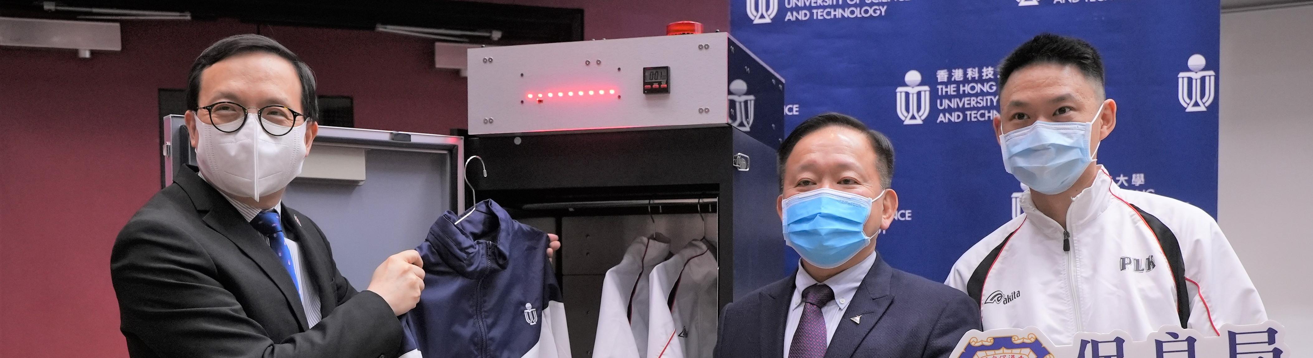 Prof. Ricky LEE Shi-Wei (middle), Chair Professor of the Department of Mechanical and Aerospace Engineering at HKUST, demonstrates how the UVC LED disinfection closet works, along with Mr. LAM Kwok-Wai (left) and Mr. Martin MAK, Principal and Assistant Warden respectively of the Po Leung Kuk Yu Lee Mo Fan Memorial School. 