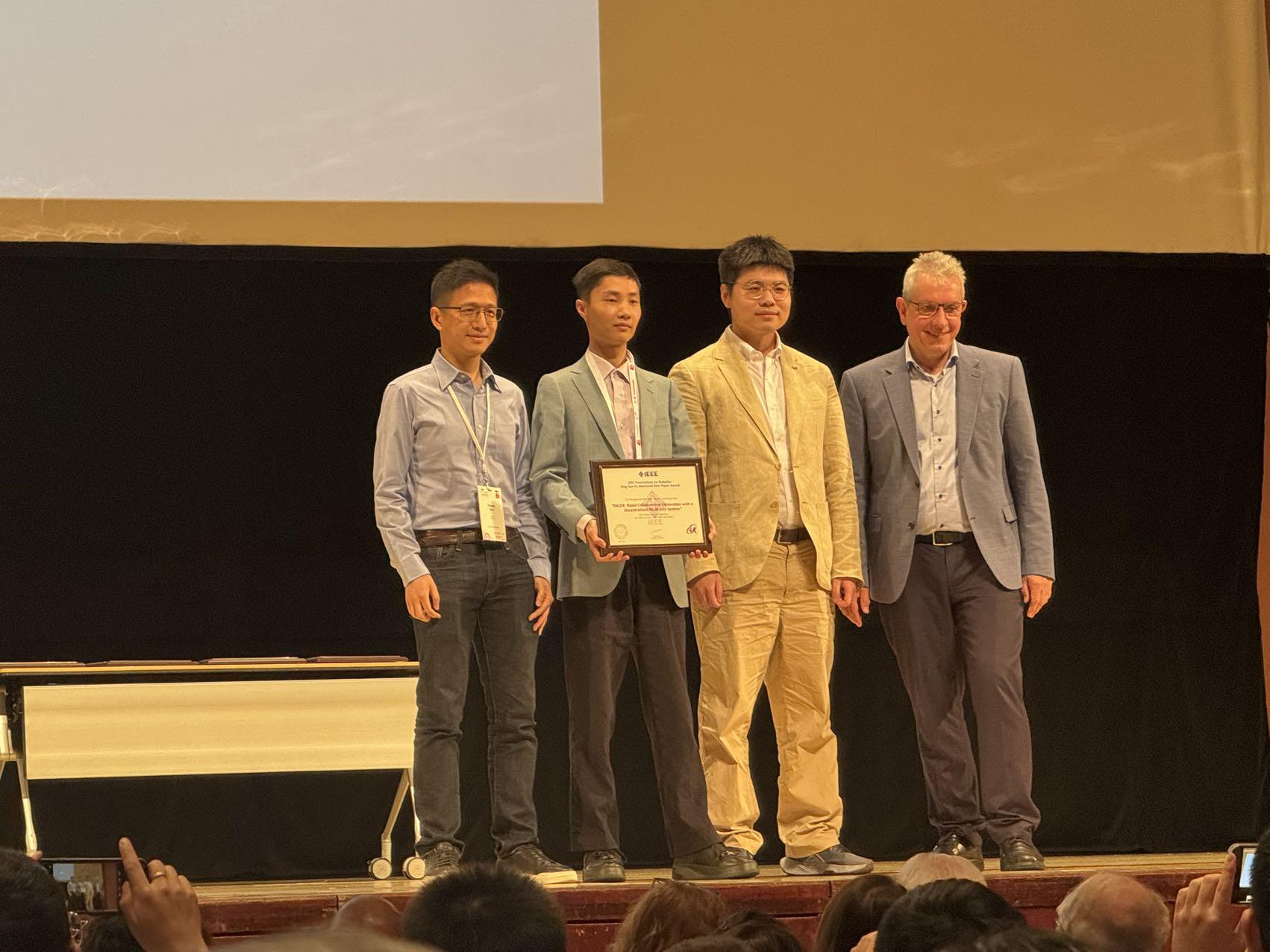 Prof. Shen Shaojie (first left) and his two former PhD students, Dr. Zhou Boyu (second left) and Dr. Xu Hao (second right), received the 2024 IEEE Transactions on Robotics King-Sun Fu Memorial Best Paper Award, which recognizes the best paper published annually in the IEEE Transactions on Robotics.