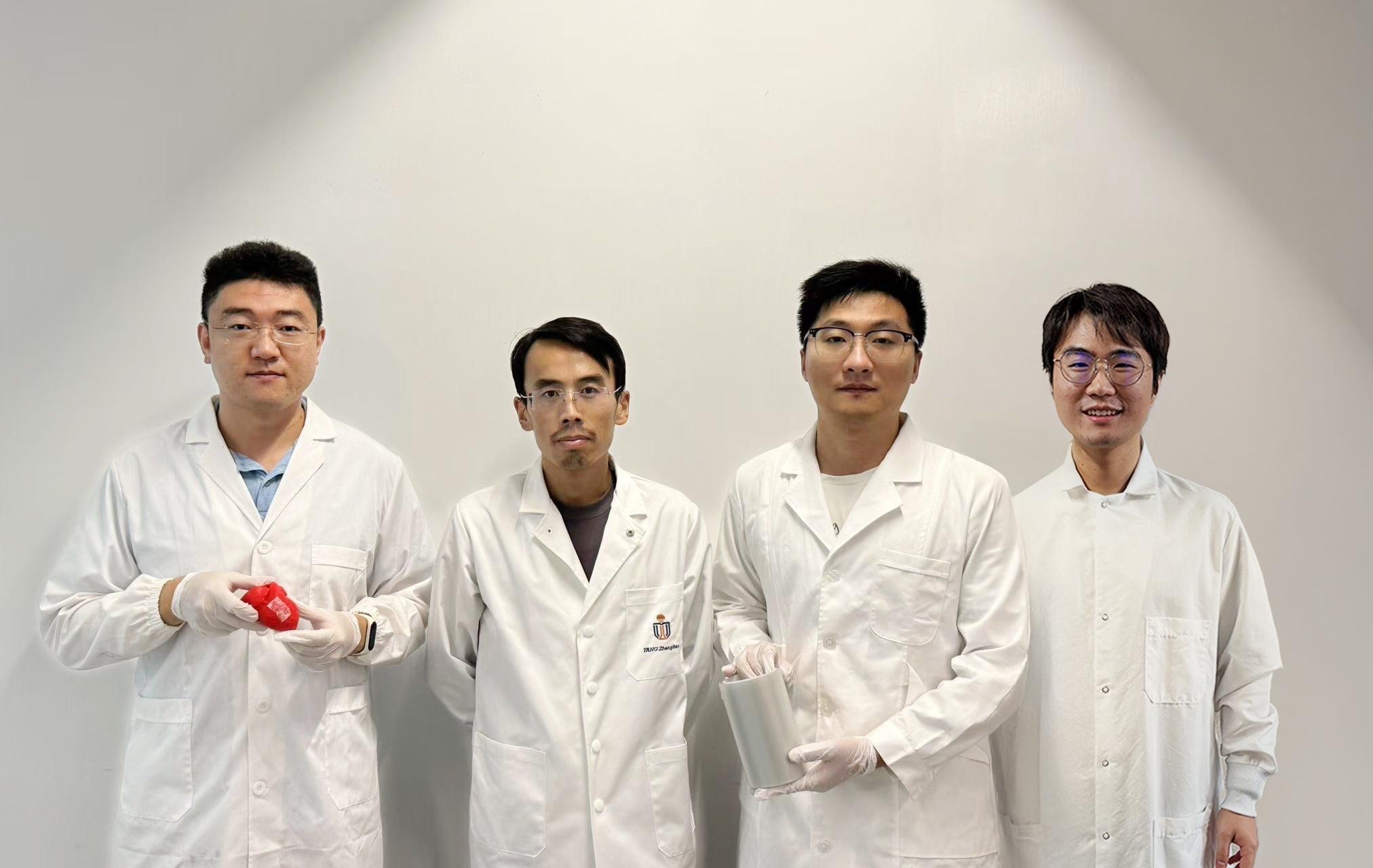 Prof. Yang Zhengbao (second left), Associate Professor at HKUST’s Department of Mechanical and Aerospace Engineering, with the three co-first authors of the study: HKUST postdoctoral fellow Dr. Li Xuemu (second right, holding a roll of printed glycine films), CityU PhD graduate Dr. Zhang Zhuomin (first right), and CityU PhD Student Zheng Yi (first left, with a glycine patch in his hands).