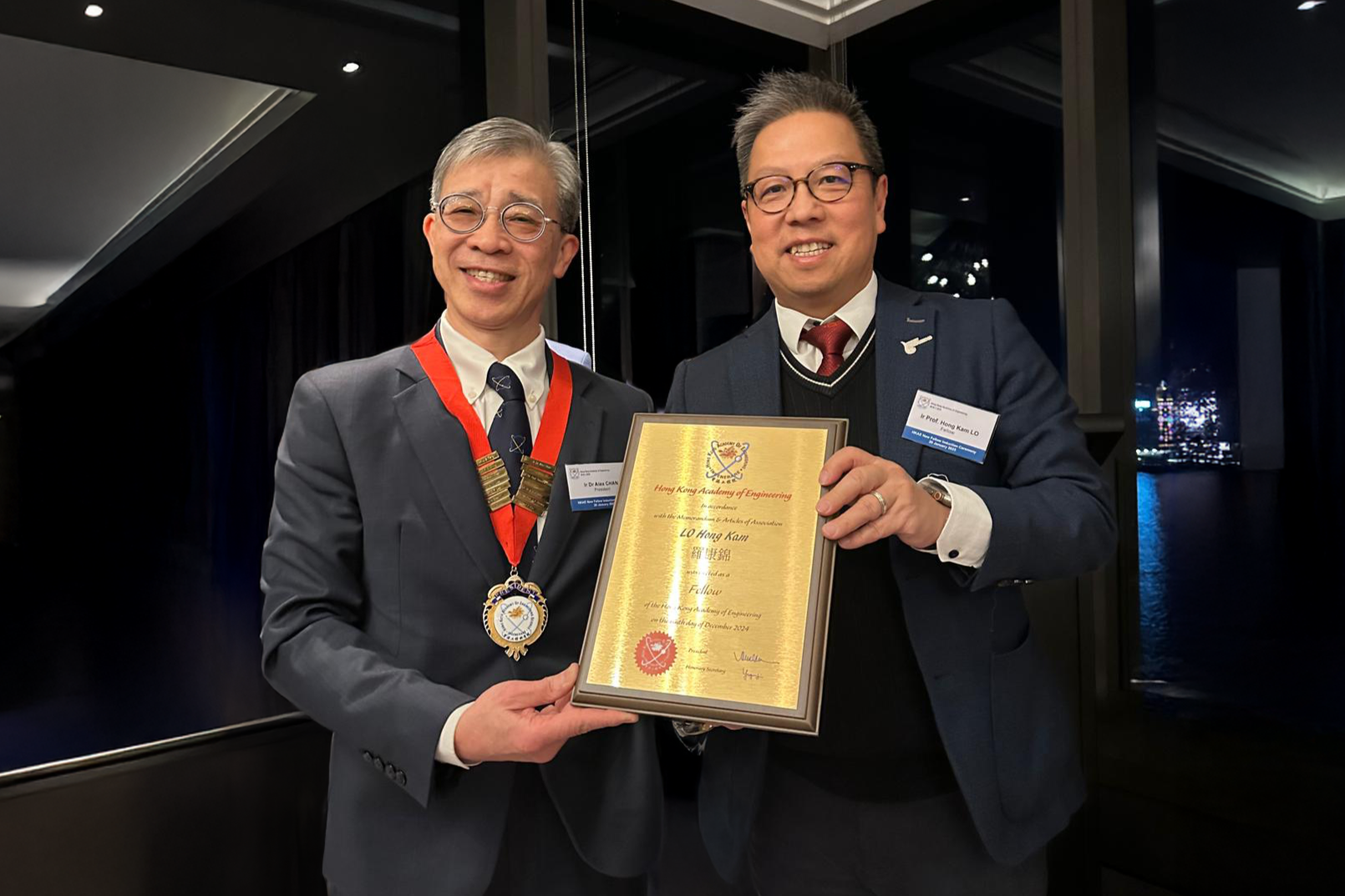 Dean of Engineering Ir Prof. Hong K. Lo, JP (right) was presented with a certificate by Ir Dr. Alex Chan Siu-Kun Chan, President of the Hong Kong Academy of Engineering, at the induction ceremony on January 20, 2025.